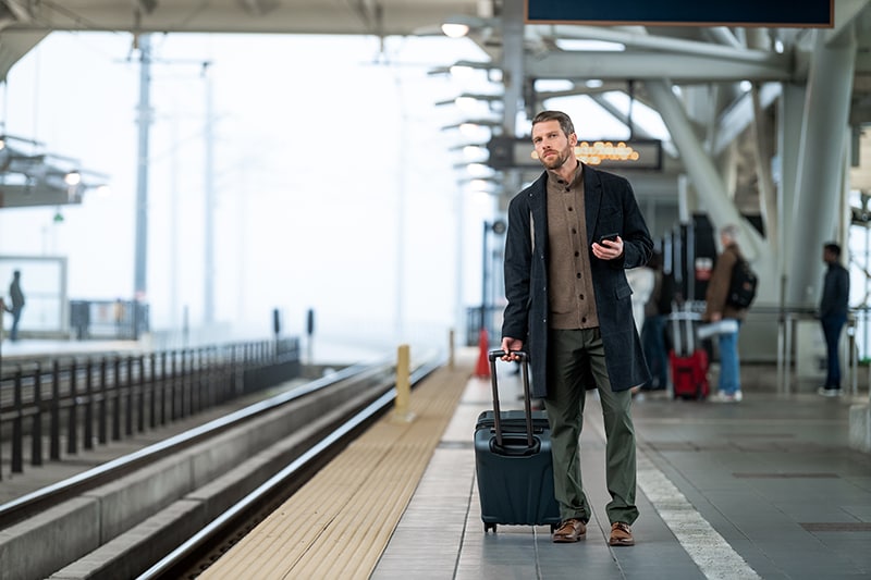 man waiting for a train at the train station