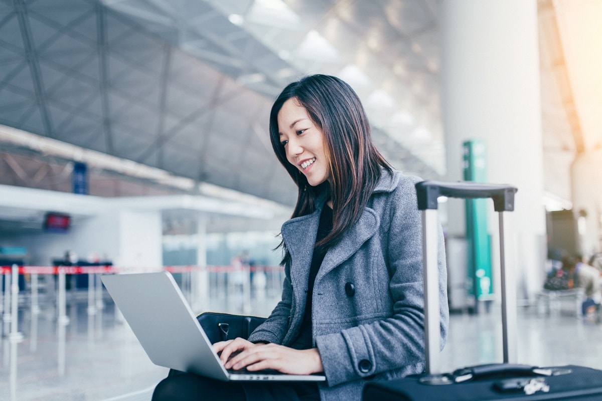 Lady sitting in airport with case next to her