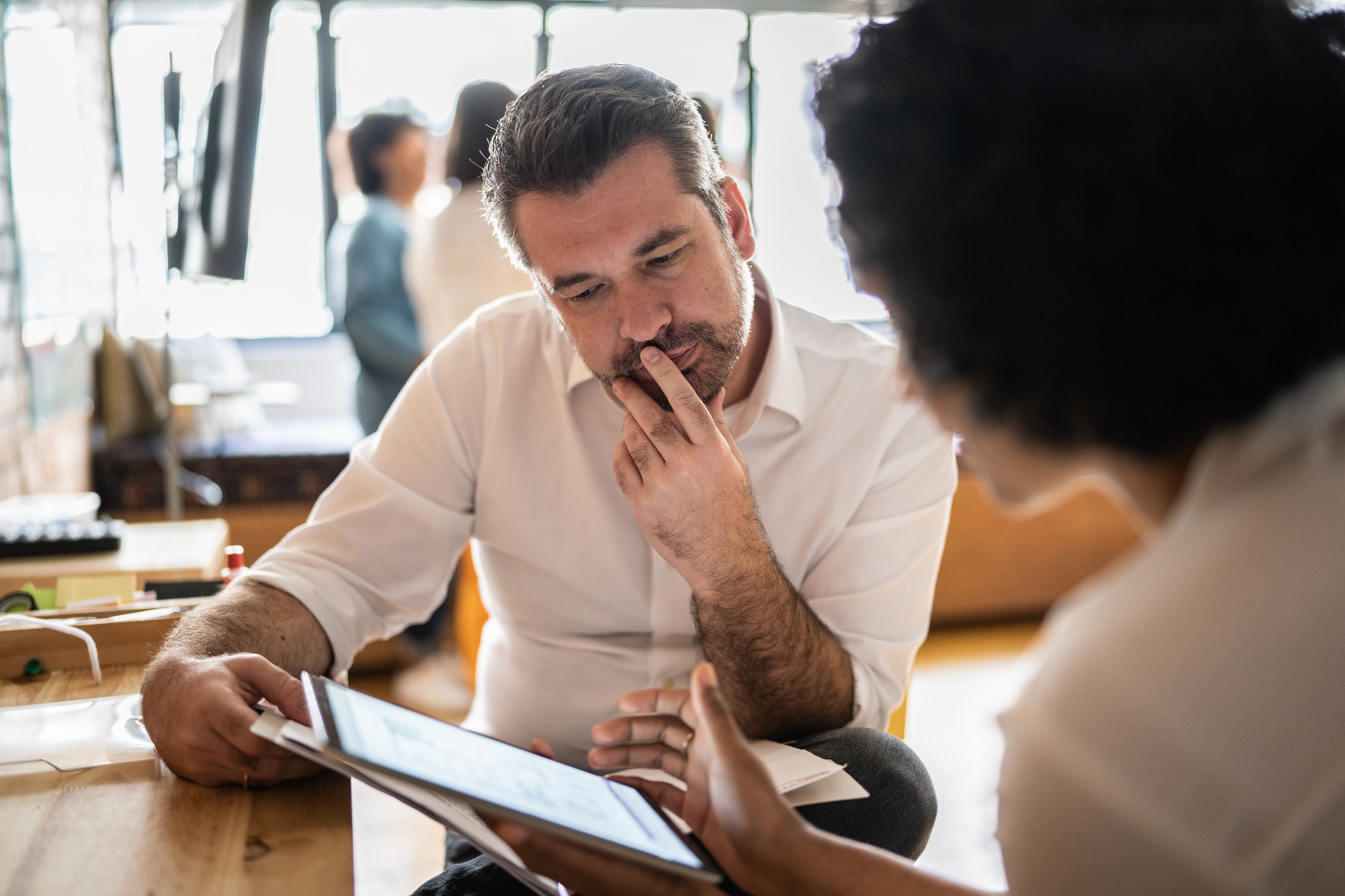 Man looking at screen with woman