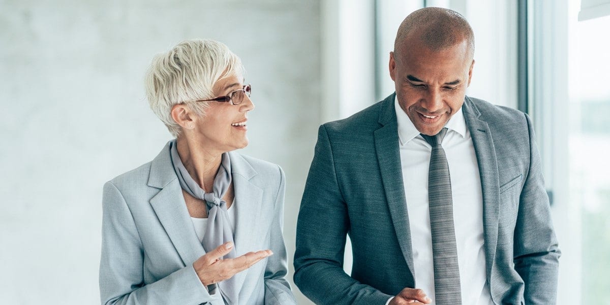 two professionals in office in discussion