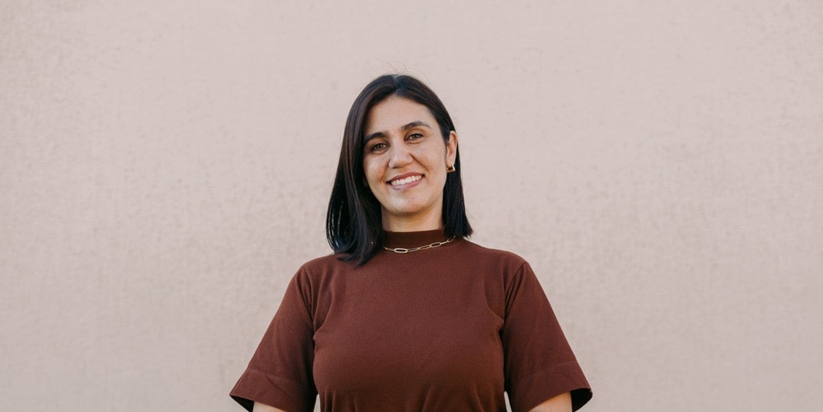 professional woman in red shirt smiling