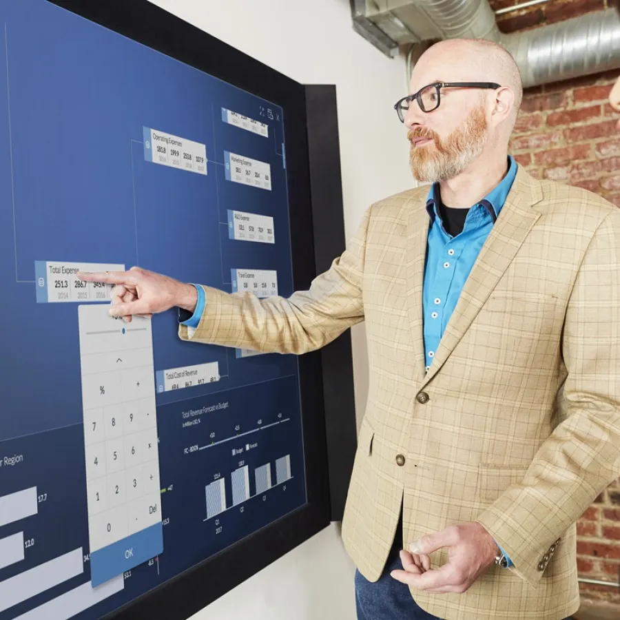 People standing in front on interactive screen